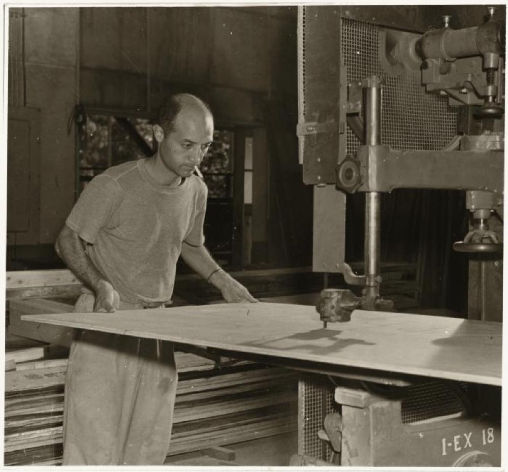 Isamu Noguchi working at a band saw in his MacDougal Alley Studio