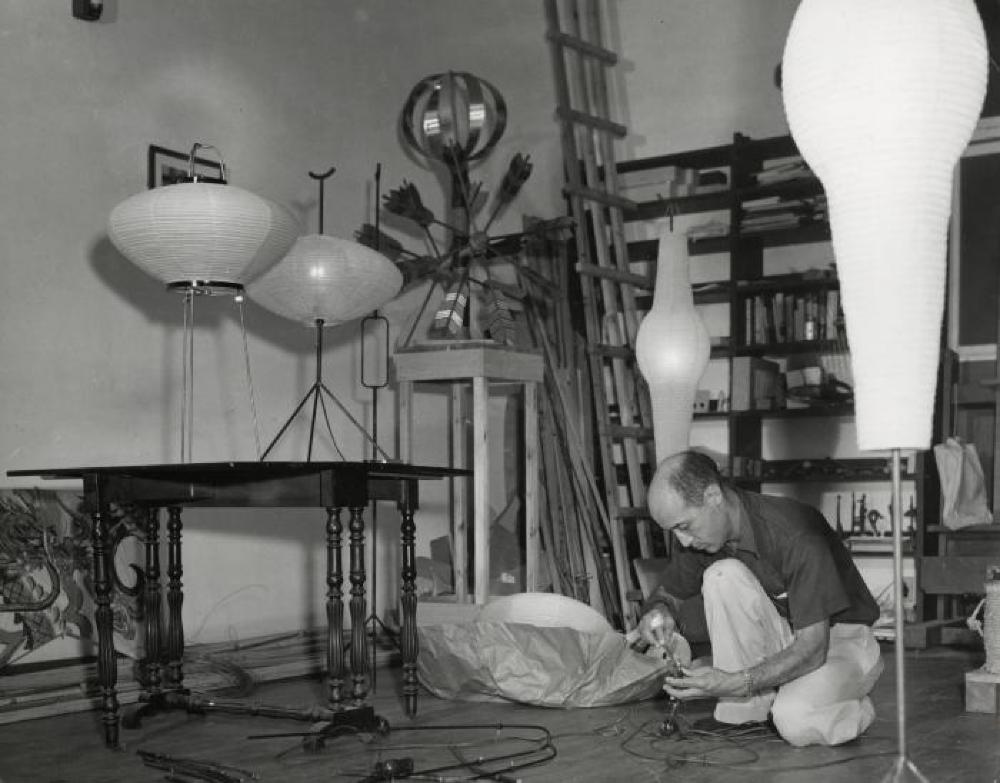 Isamu Noguchi working on Akari prototypes (models 9, 26, and 14 on various bases) in Japan