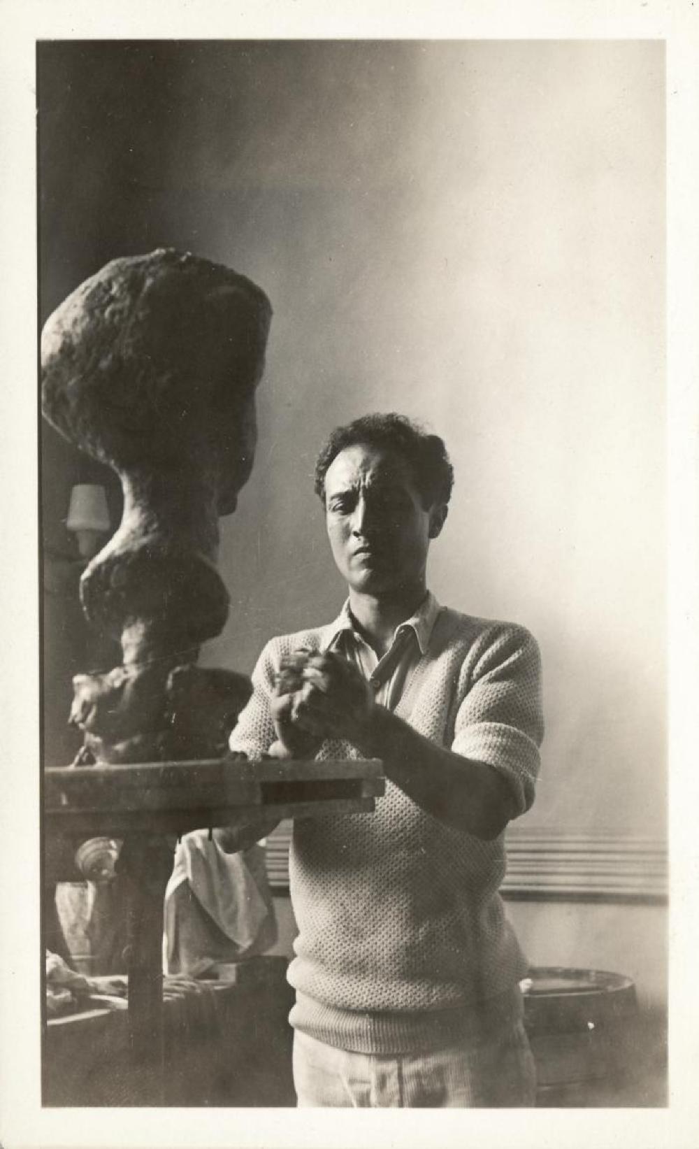 Isamu Noguchi working on portrait head of Mary Poore