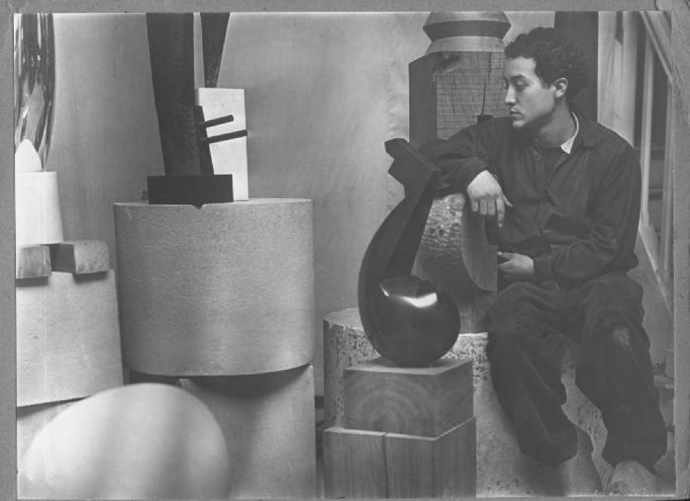 Isamu Noguchi in his Gentilly Studio at 11 rue Dedouvre with "Loud Whisper," "Beguine," and other works in process, and various bases.