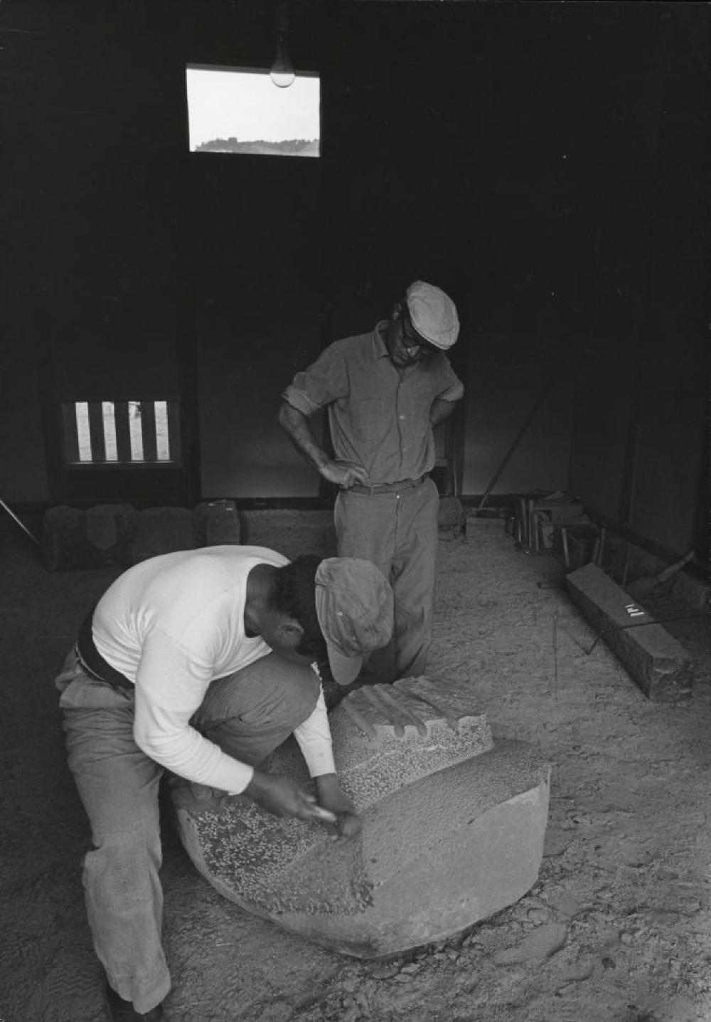 Isamu Noguchi and assistant at work on "The Seeker Sought" at his studio in Mure (Shikoku, Japan)