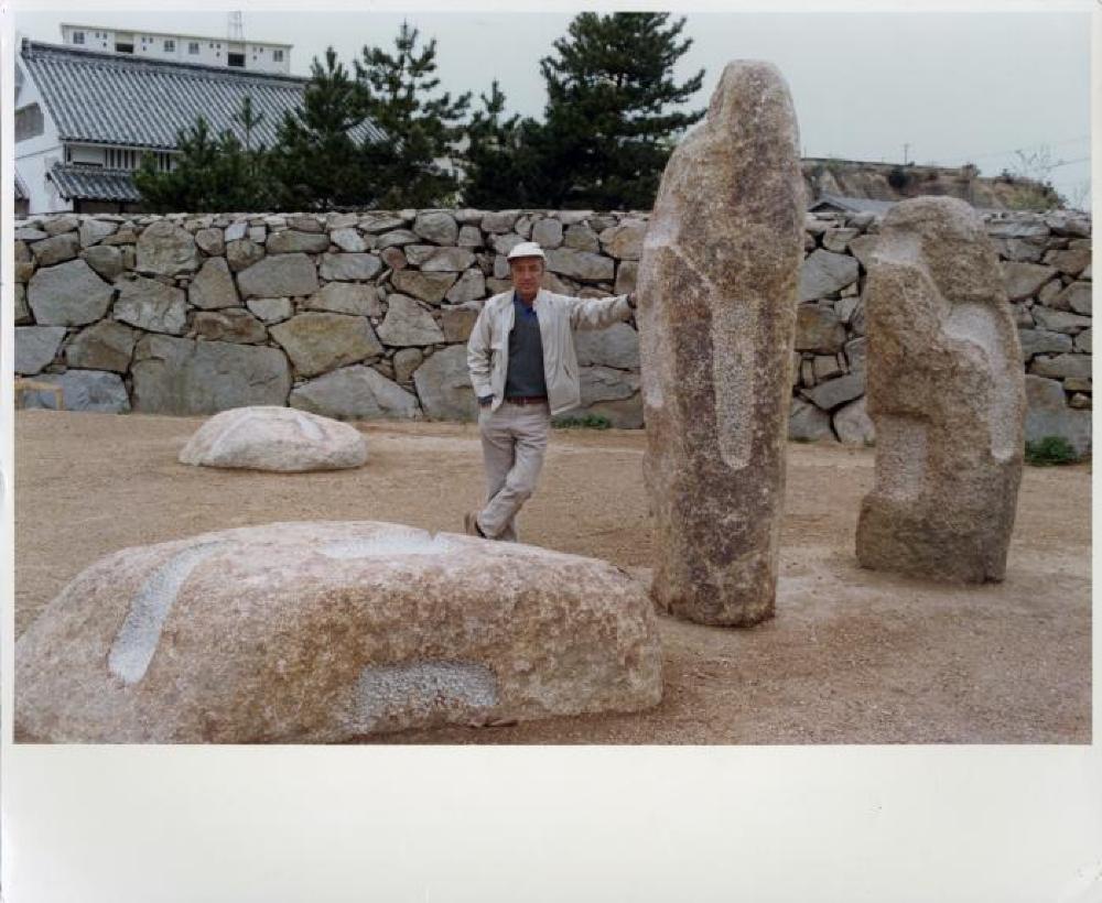 Isamu Noguchi with sculptures at his Mure Studio