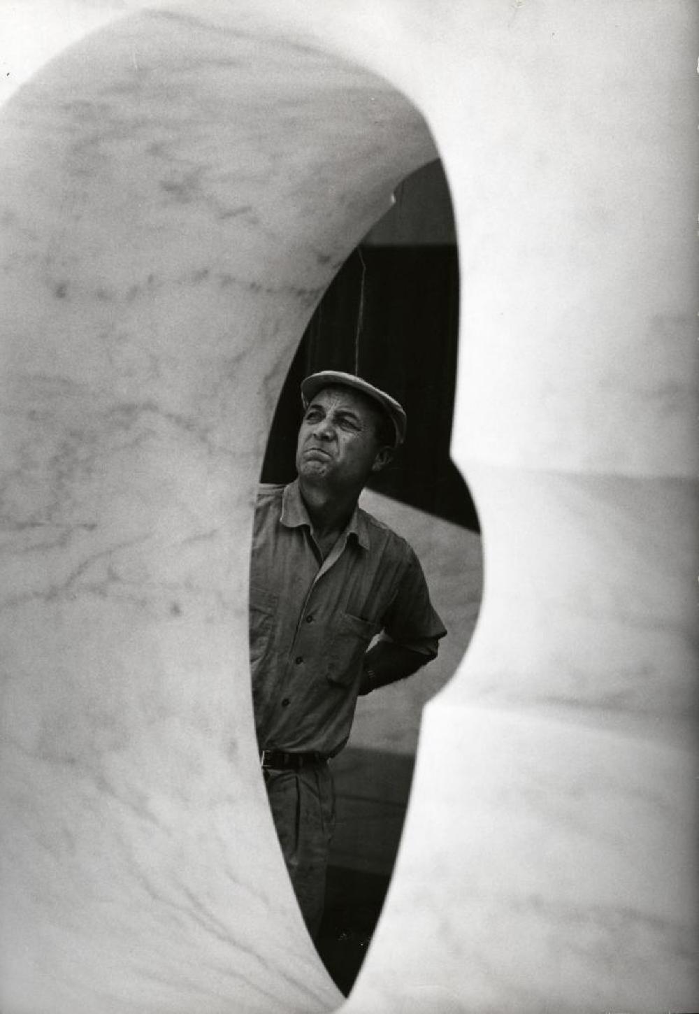 Isamu Noguchi working on marble element for the Sunken Garden at Beinecke Library, Yale