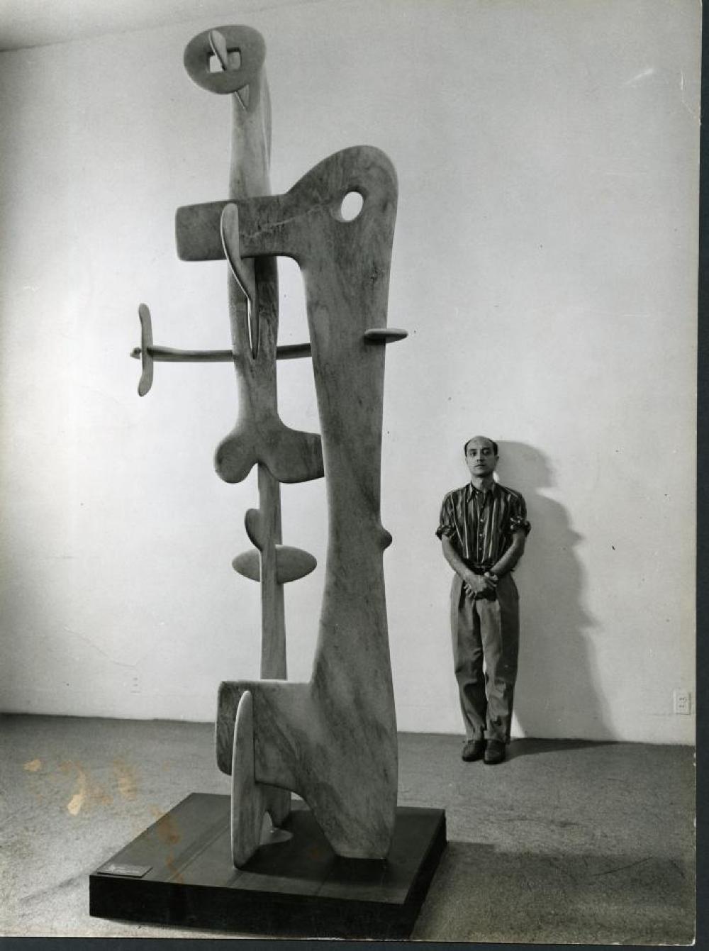 Isamu Noguchi with Kouros at Fourteen Americans exhibition, Museum of Modern Art, New York