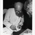 Noguchi signing catalogues at opening reception for Noguchis Imaginary Landscapes, Detroit Institute of Fine Arts, April 10 – June 10 1979 (travel from Walker Art Center).