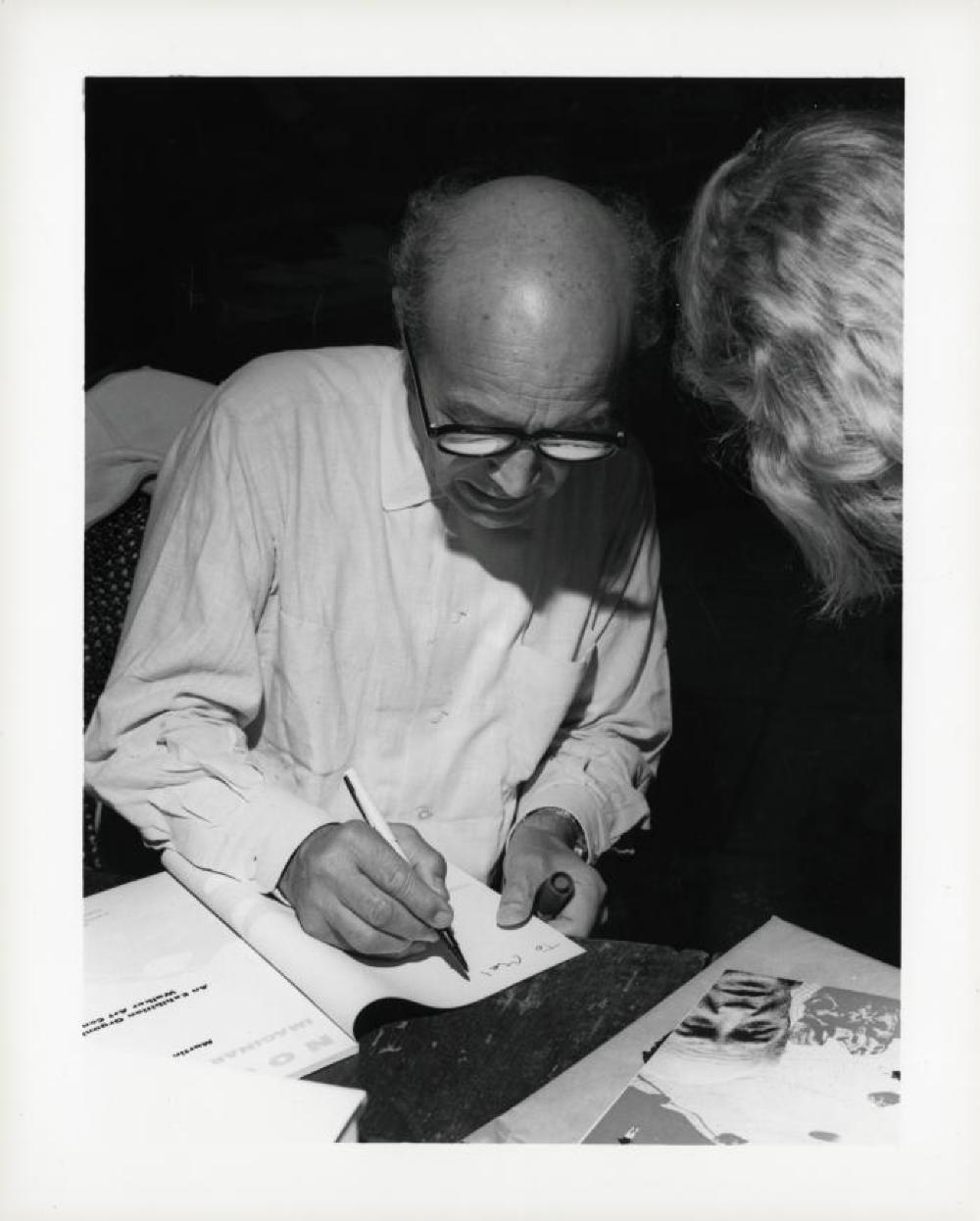 Noguchi signing catalogues at opening reception for "Noguchi's Imaginary Landscapes," Detroit Institute of Fine Arts, April 10 – June 10 1979 (travel from Walker Art Center).