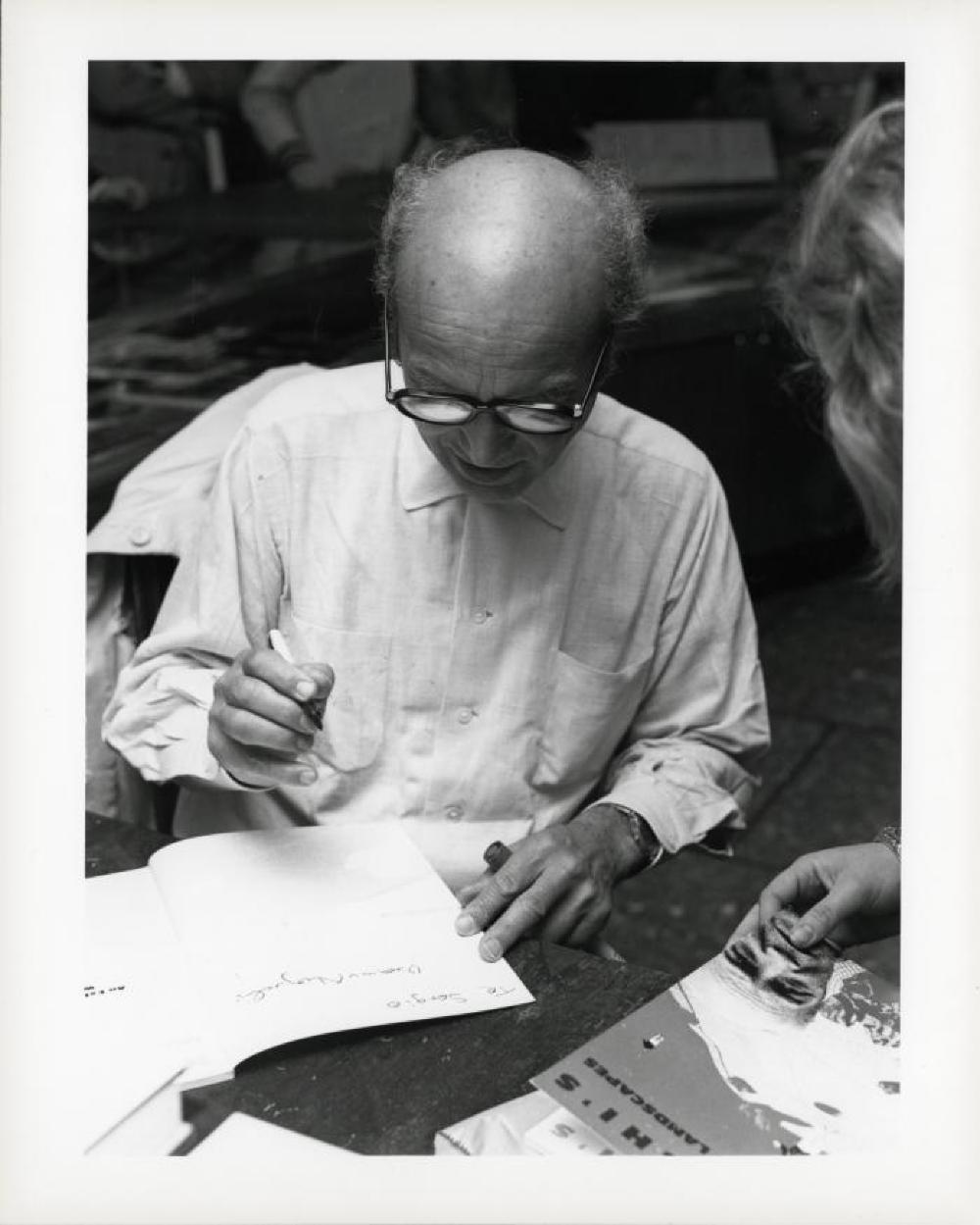 Noguchi signing catalogues at opening reception for "Noguchi's Imaginary Landscapes," Detroit Institute of Fine Arts, April 10 – June 10 1979 (travel from Walker Art Center).