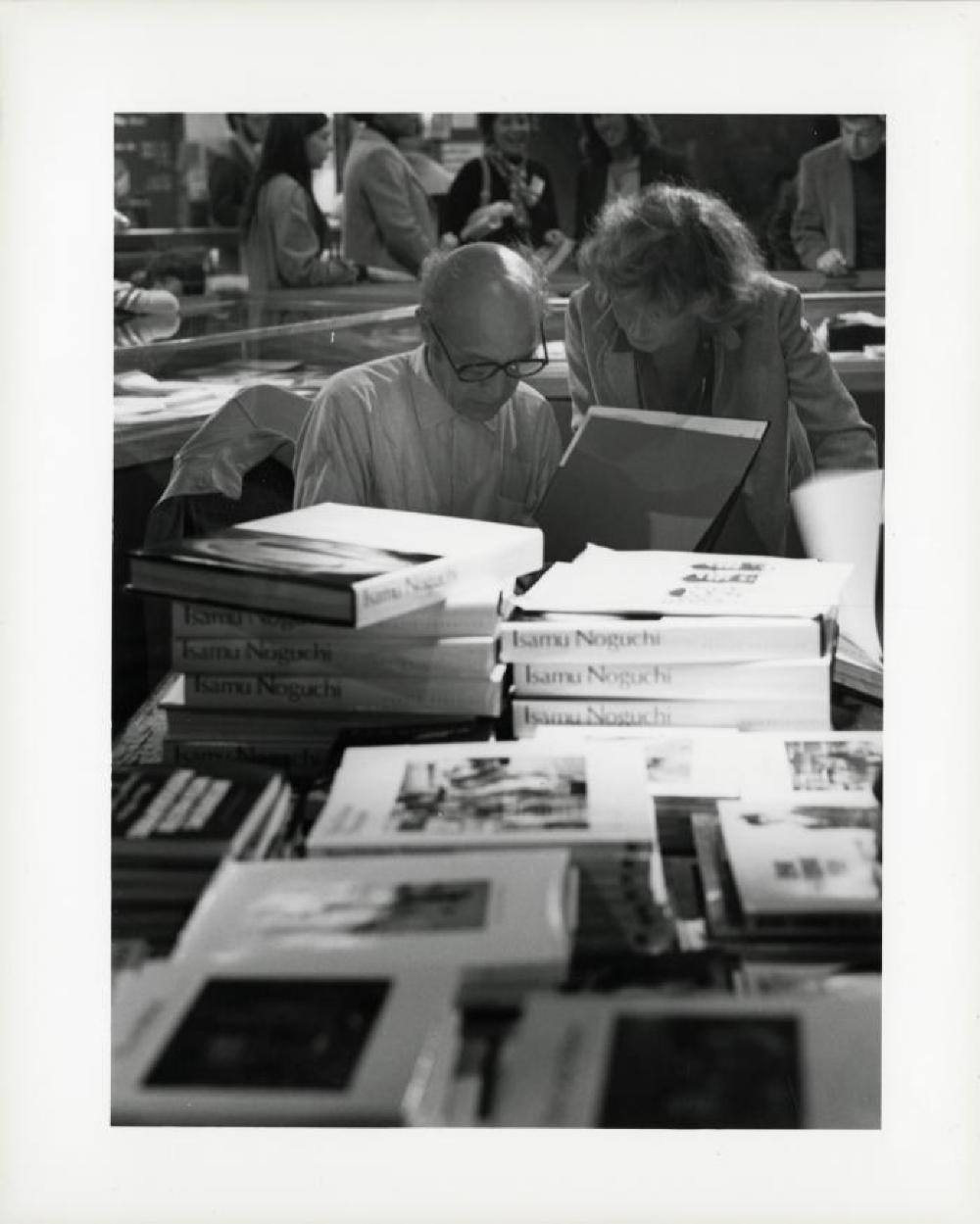 Noguchi signing catalogues at opening reception for "Noguchi's Imaginary Landscapes," Detroit Institute of Fine Arts, April 10 – June 10 1979 (travel from Walker Art Center).