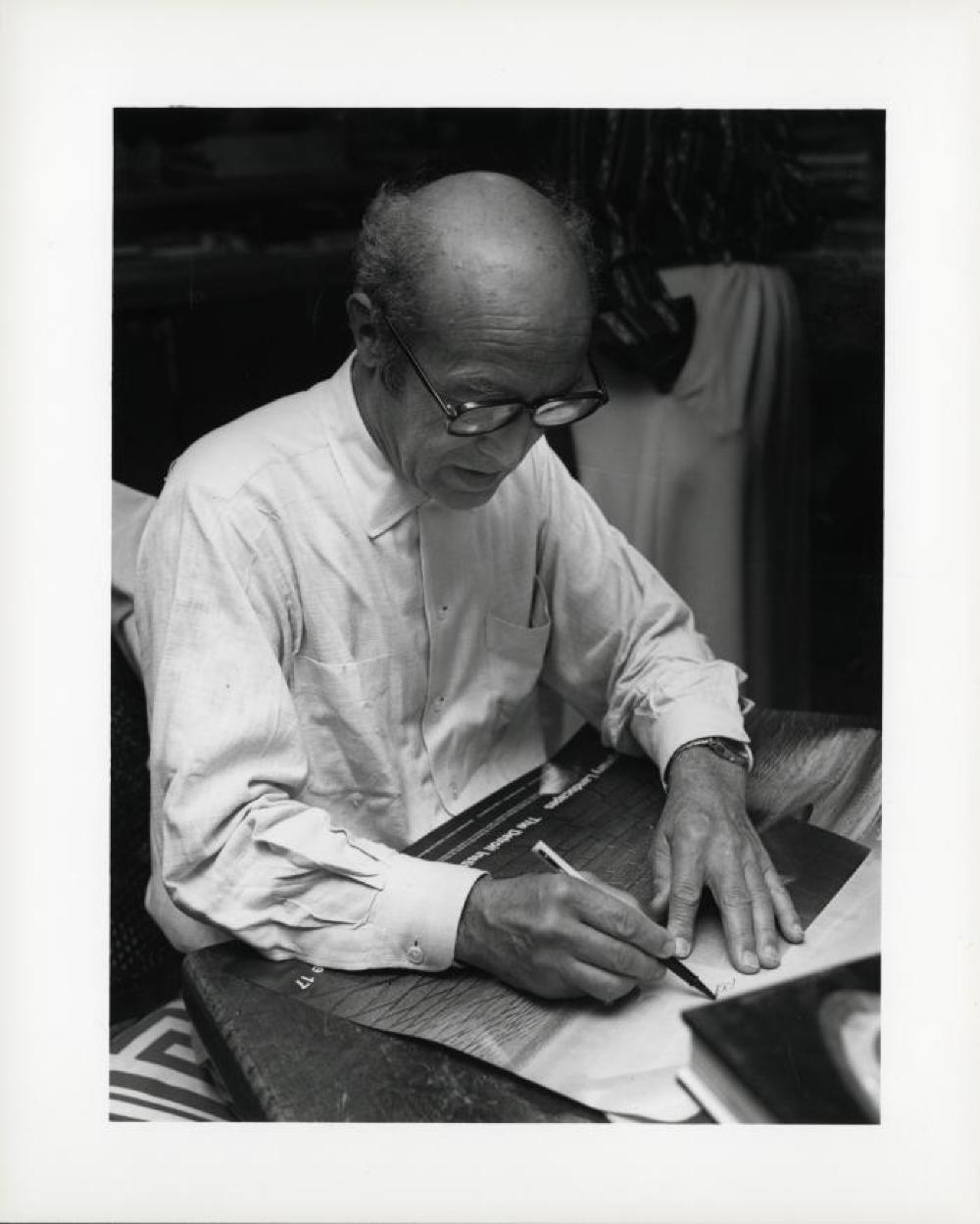 Noguchi signing catalogues at opening reception for "Noguchi's Imaginary Landscapes," Detroit Institute of Fine Arts, April 10 – June 10 1979 (travel from Walker Art Center).