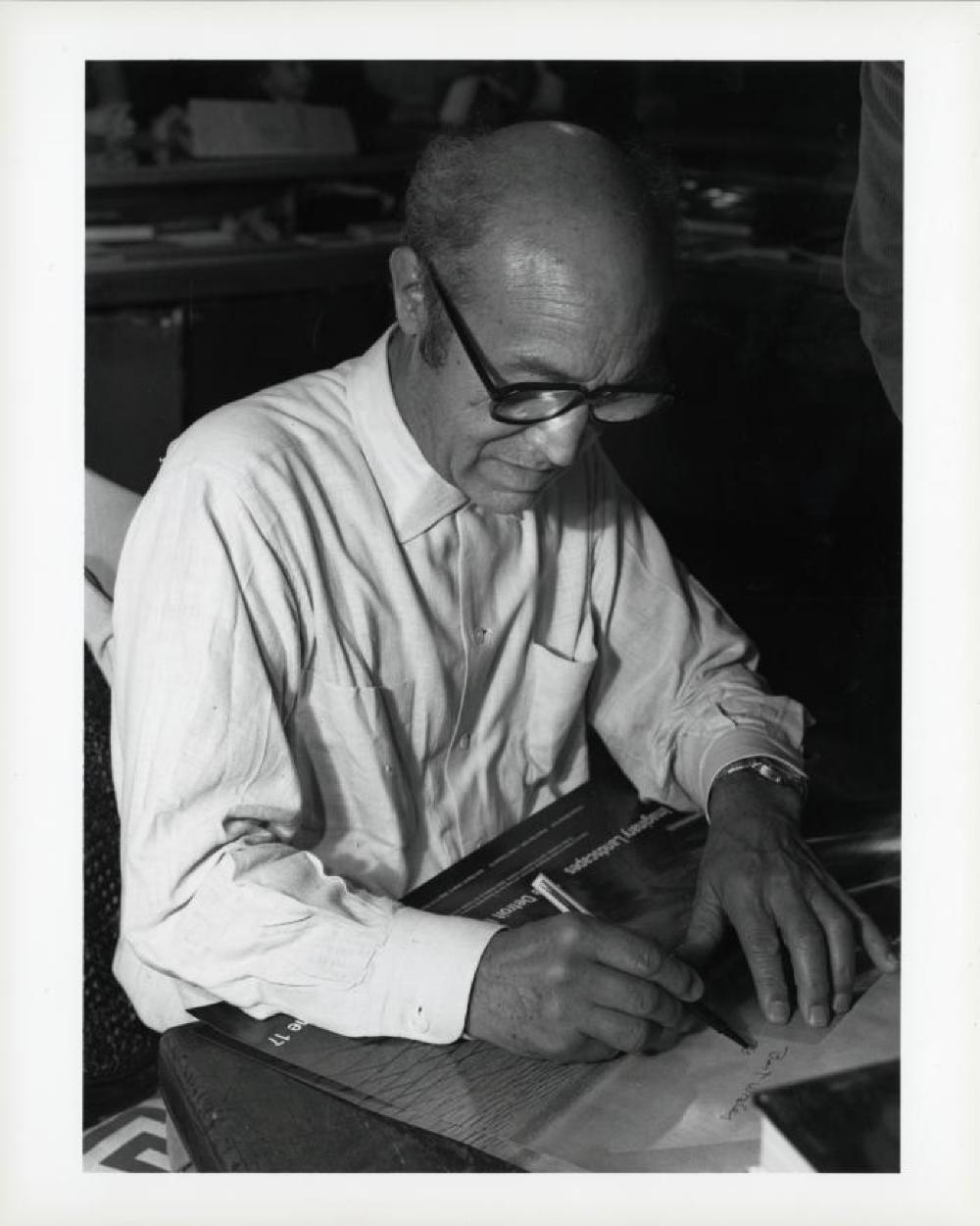 Noguchi signing catalogues at opening reception for "Noguchi's Imaginary Landscapes," Detroit Institute of Fine Arts, April 10 – June 10 1979 (travel from Walker Art Center).