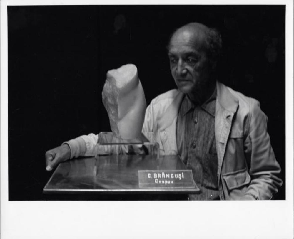 Isamu Noguchi in Romania with Brancusi sculpture, The Kiss